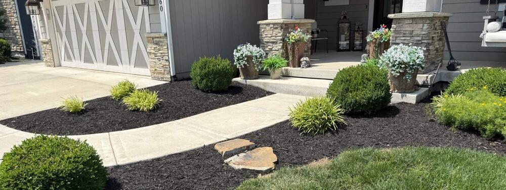 Well-maintained landscape beds with fresh mulch