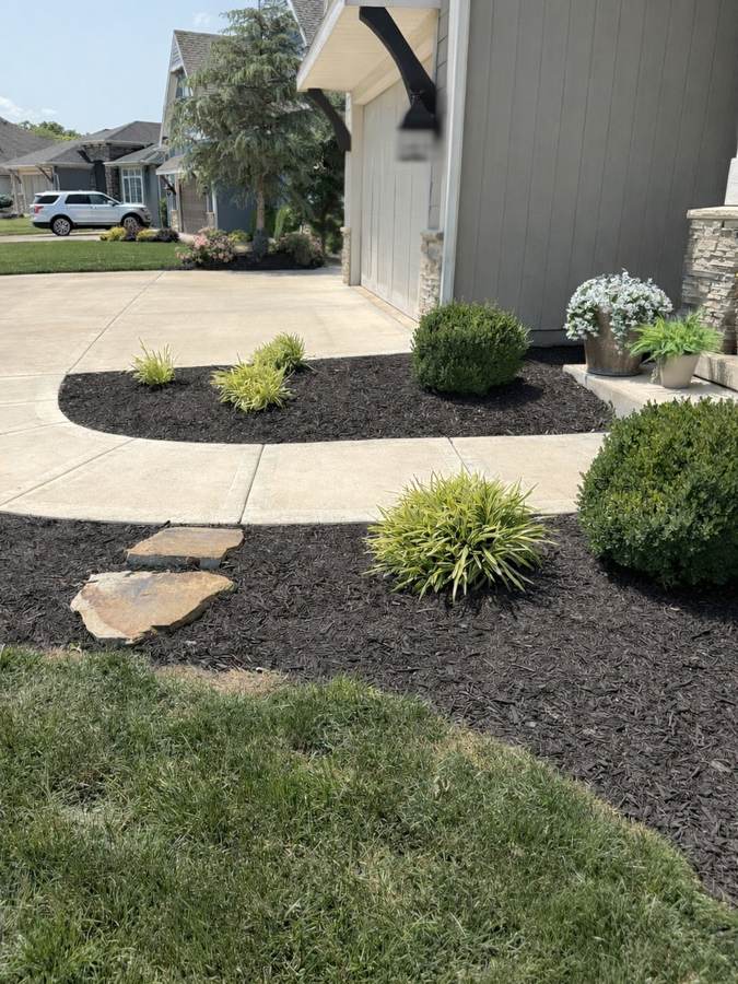 Professional mulch installation in landscape beds - Johnson County